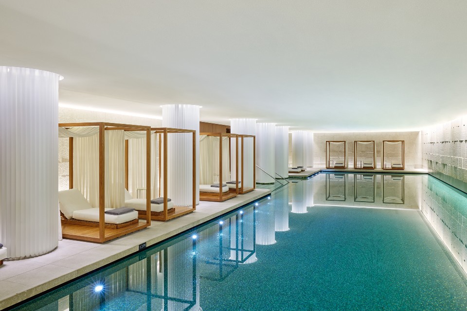 Colonnaded indoor swimming pool and cabanas at Bvlgari Hotel London