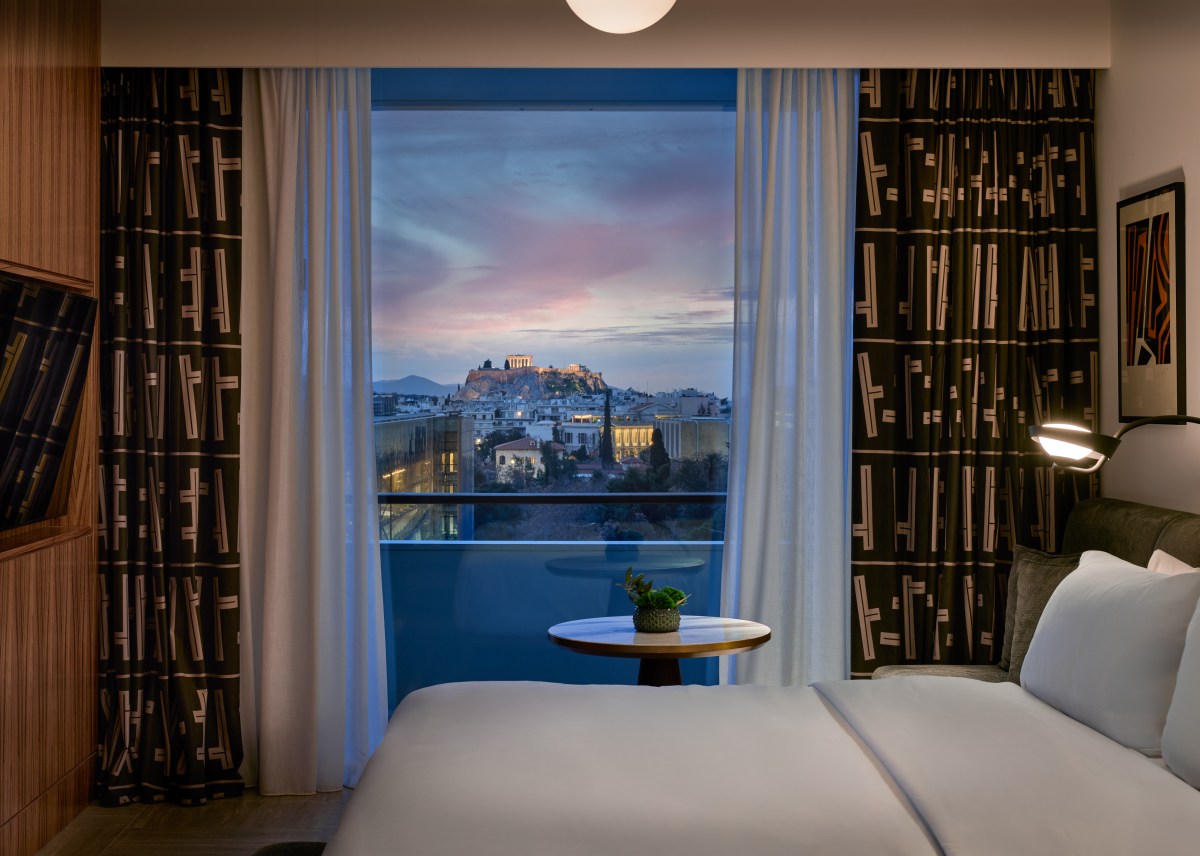 Suite window and evening city view at Conrad Athens The Ilisian